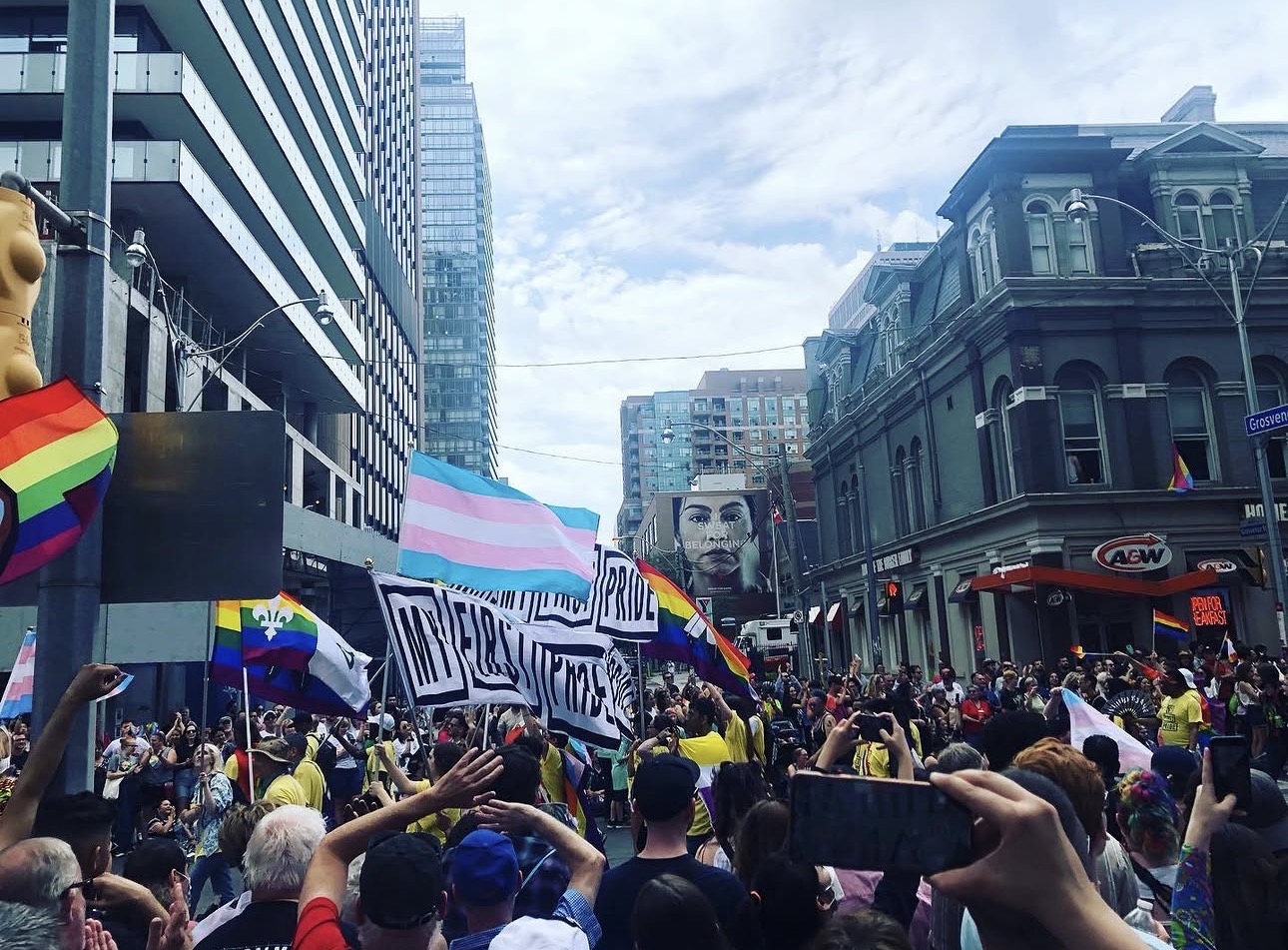 Toronto Pride parade with rainbow and trans flags
